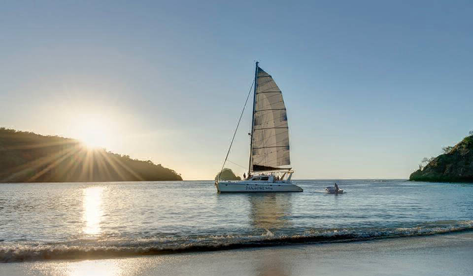 sailing at sunset flamingo beach catamaran tour
