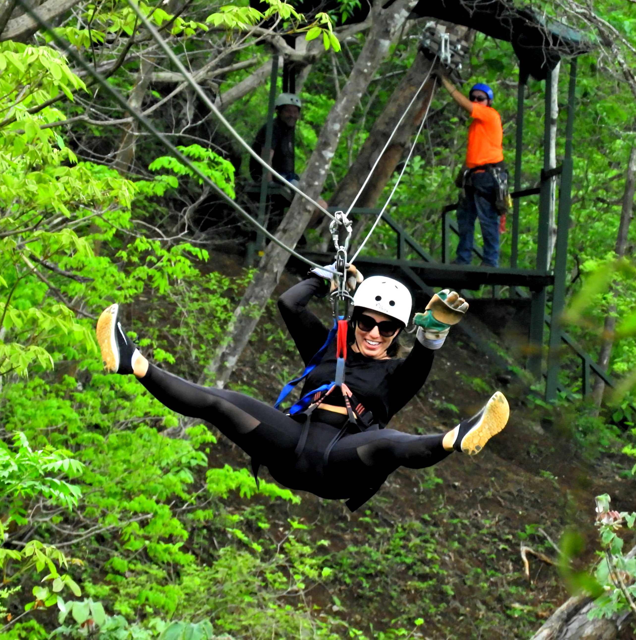 Ziplining in Flamingo Beach Costa Rica with woman flying through tropical forest